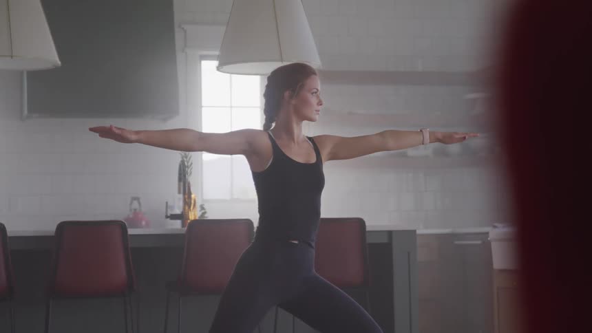 A woman is doing yoga indoors