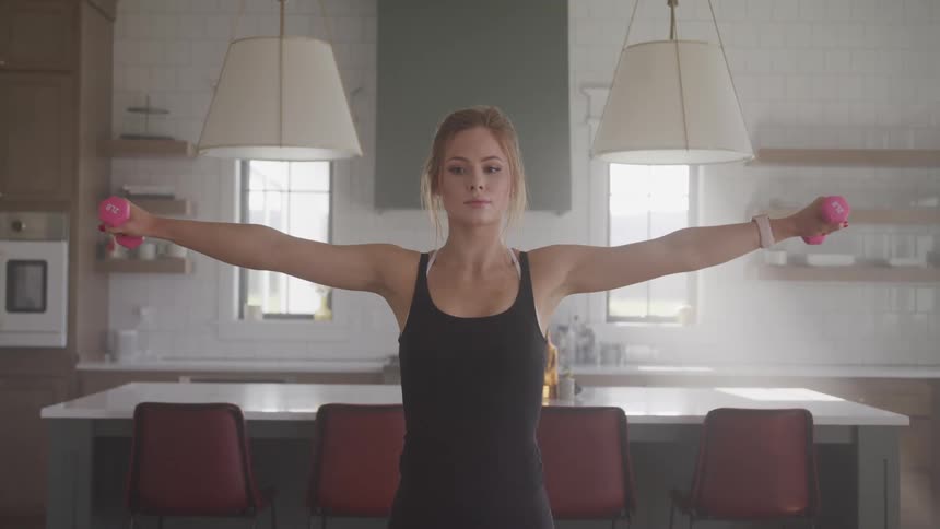 A woman is stretching indoors