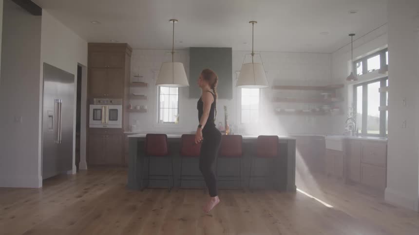 A woman jumping rope at home