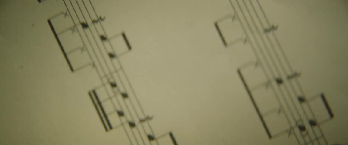 A light shines on a music sheet