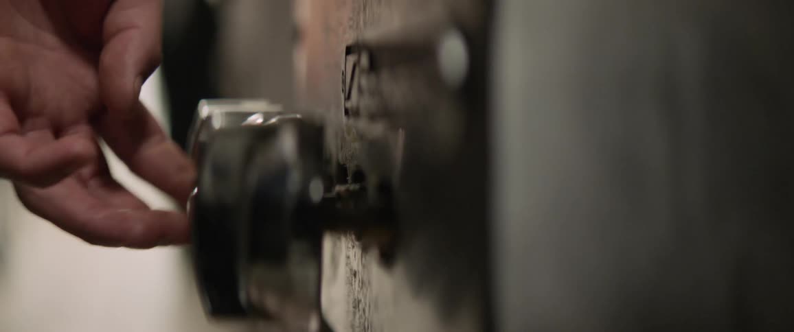 A man turns the knob on the stove