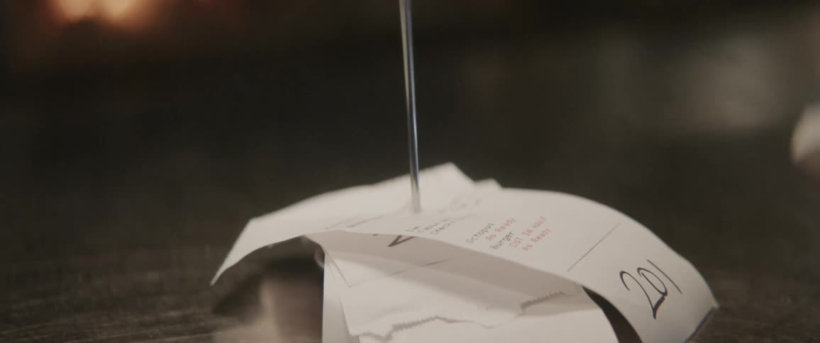 A receipt is put through a metal stake