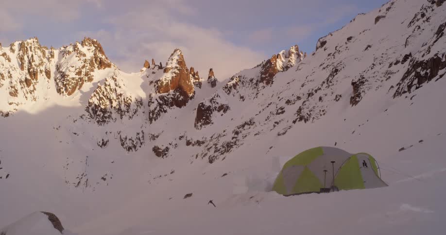A tent on the side of a snowy mountain