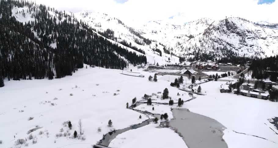 The river runs through the snow covered fields