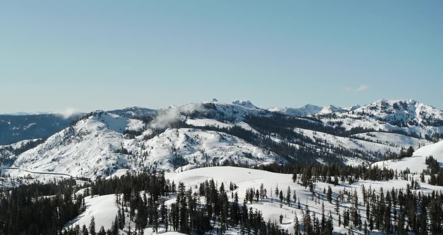 Aerial view of the snow covered landscape in the mountains at winter