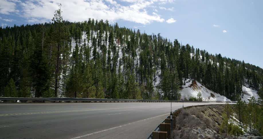 The cars drive around the large highway