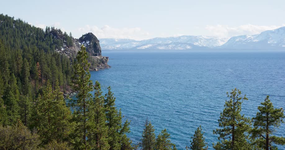 Landscape view of a forest and lake with mountains in the distance