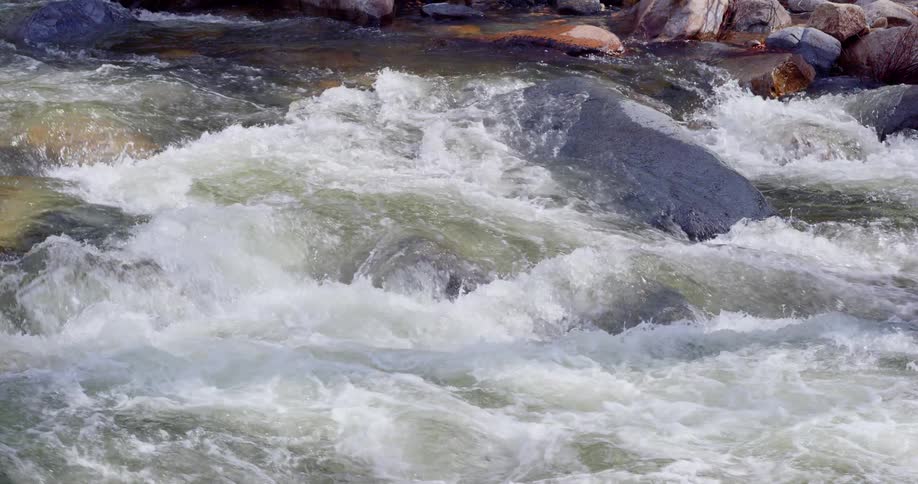Rapids in a river going over large rocks