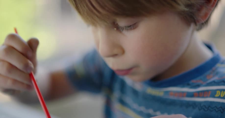 A little boy painting a picture outside