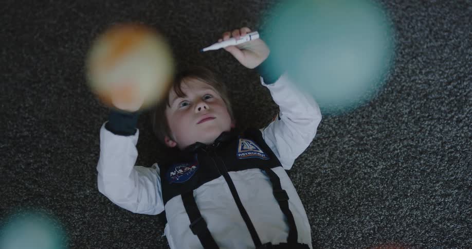 A child is playing with toy planes