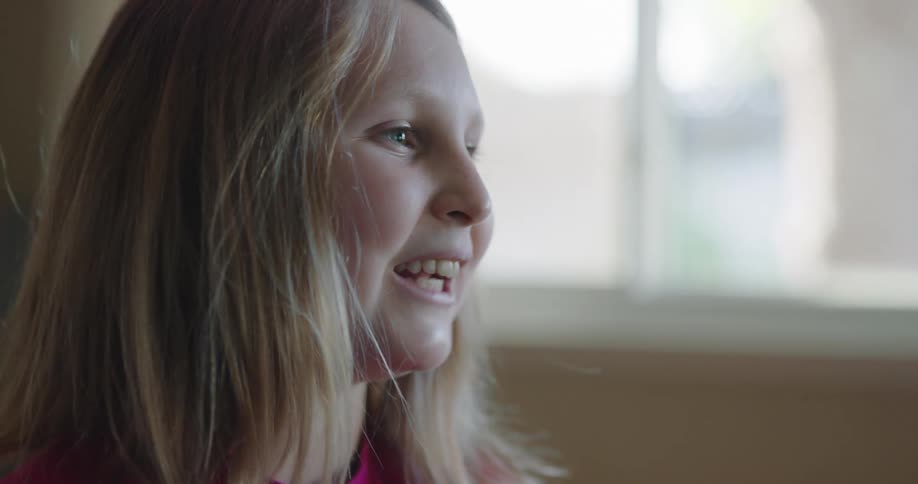 A young girl talks with someone