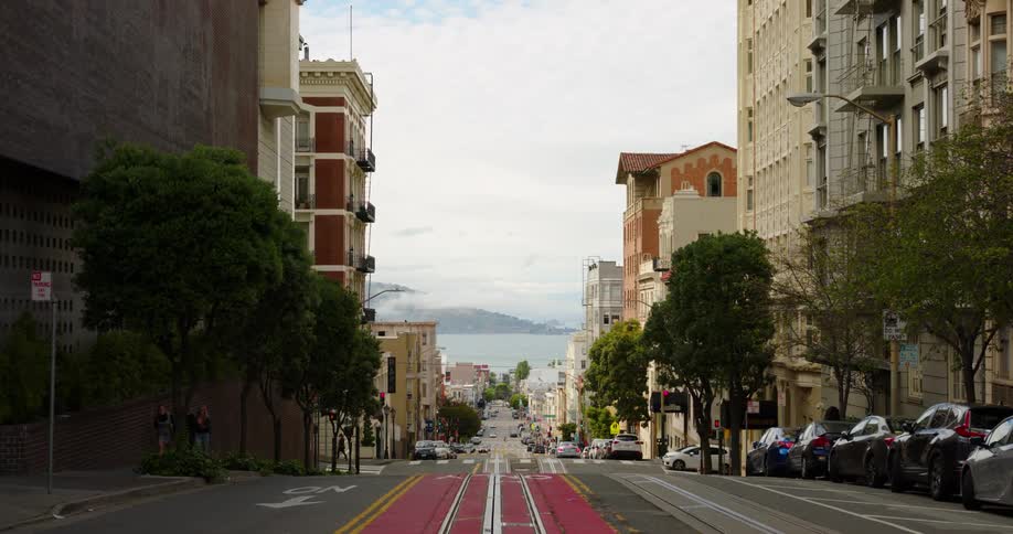 A single car drives through the empty city