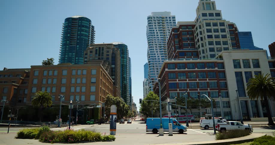 People are driving past the buildings in the city