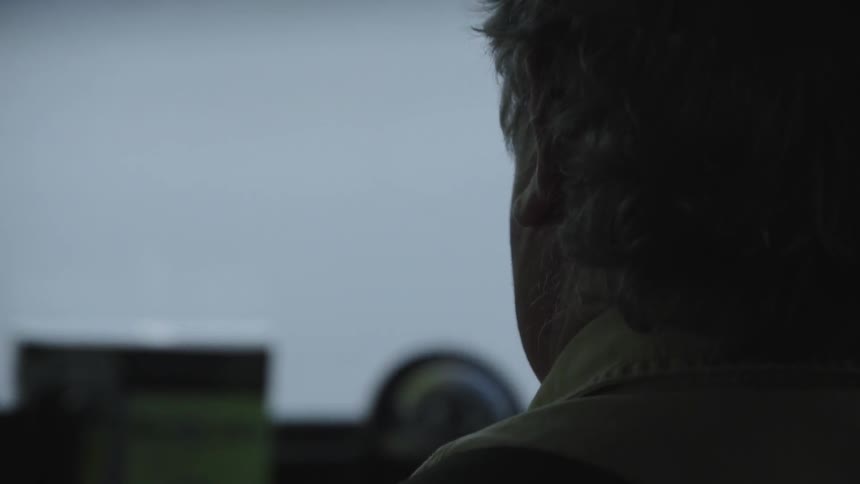 A man staring off into the distance and moving his head