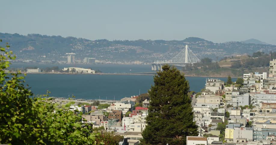 A city surrounding a bay on a sunny day