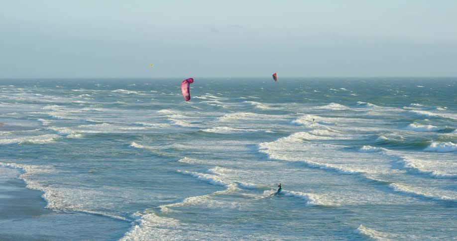 People are parasailing in the ocean