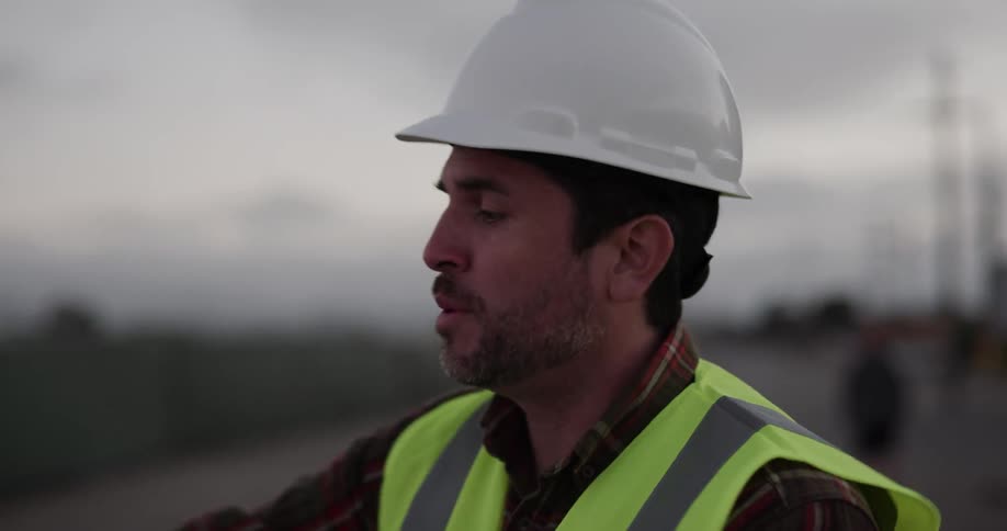 An employee talks with someone on a construction site