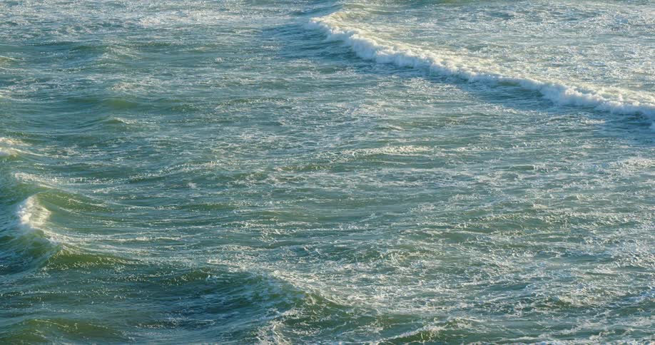 Waves form parallel lines in the ocean