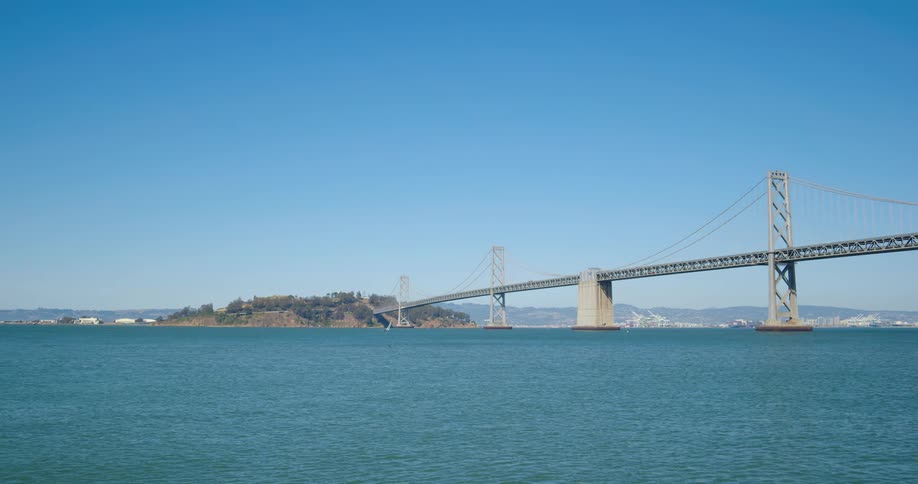 A bridge spans water and ends on an island