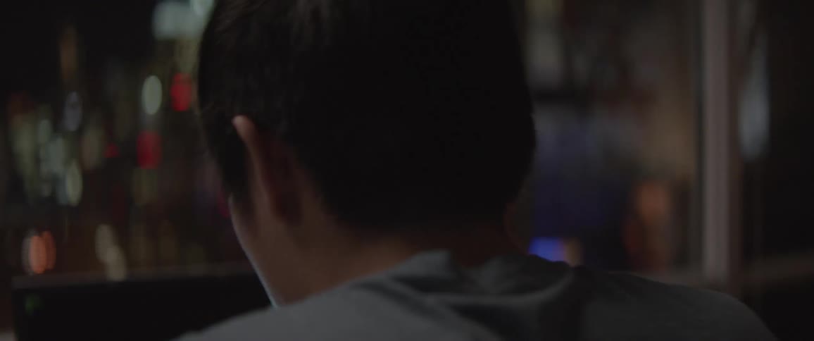 A man is using his laptop and smiling
