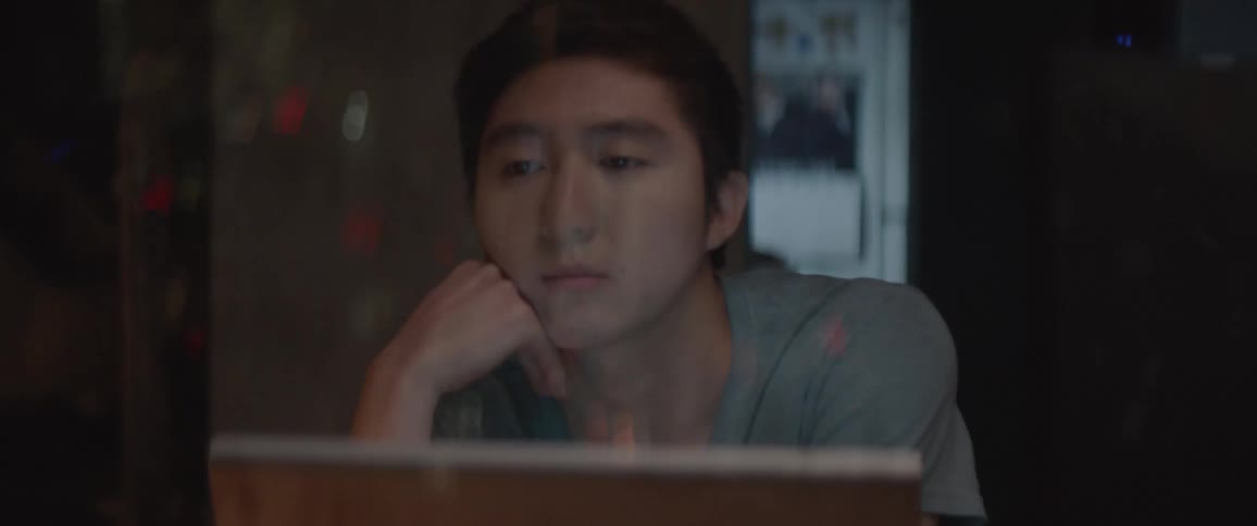 Man sits at a desk thinking