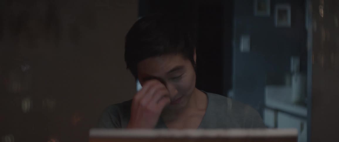 A man is talking and using a computer