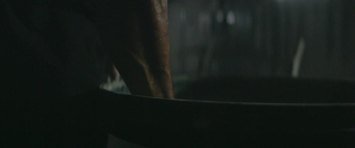 A person mixes something in a dark bowl