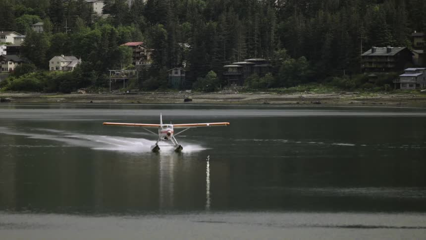 A seaplane lands in a harbor