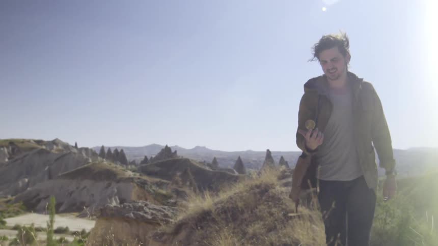 A man uses a compass in the wilderness