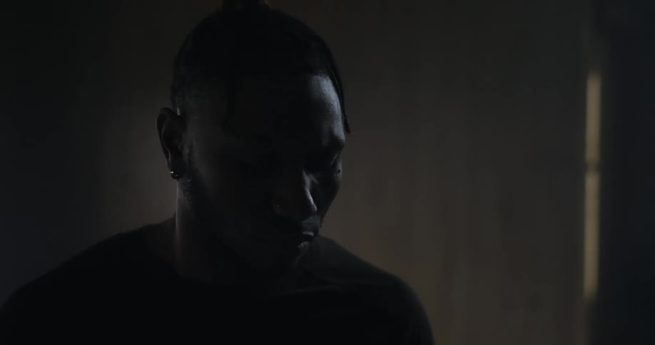 A young black man inside a room