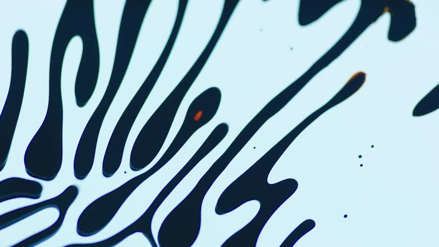 Black ink moves in a pattern