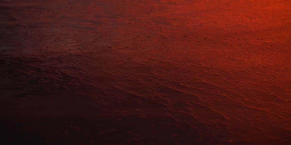 The red sky reflects on the water