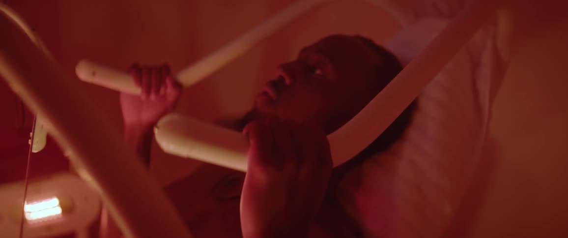 A man holds onto handles as a red light blinks