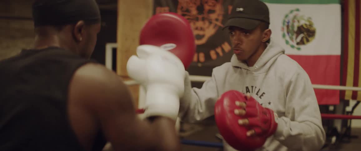 Two boxers train in a boxing ring