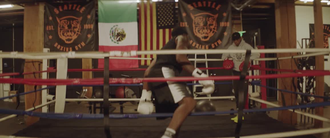 A boxer climbs into the ring to train