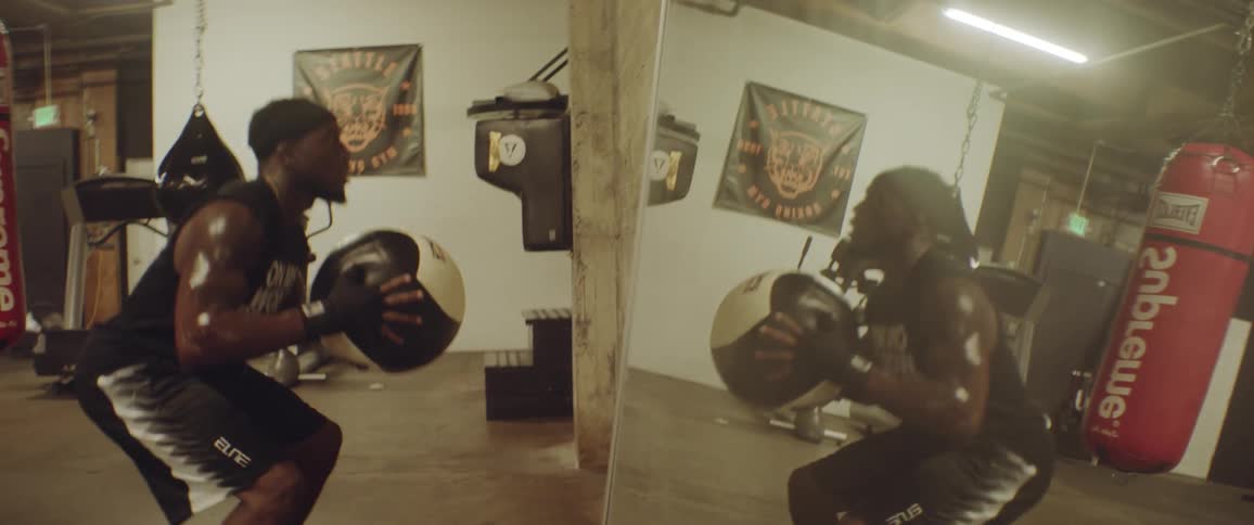 Man throws a medicine ball at a wall