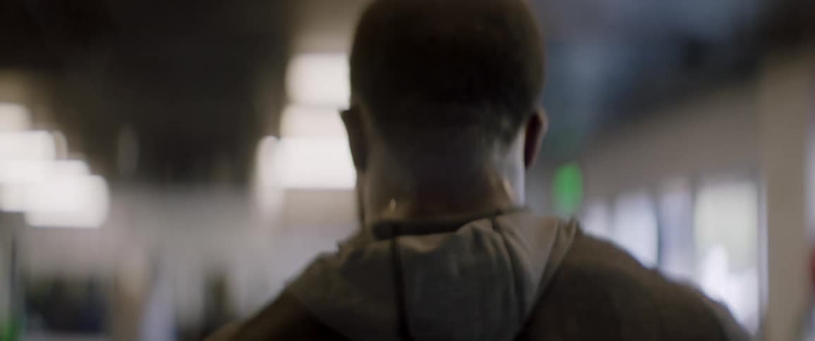 A man sweats while walking in a gym