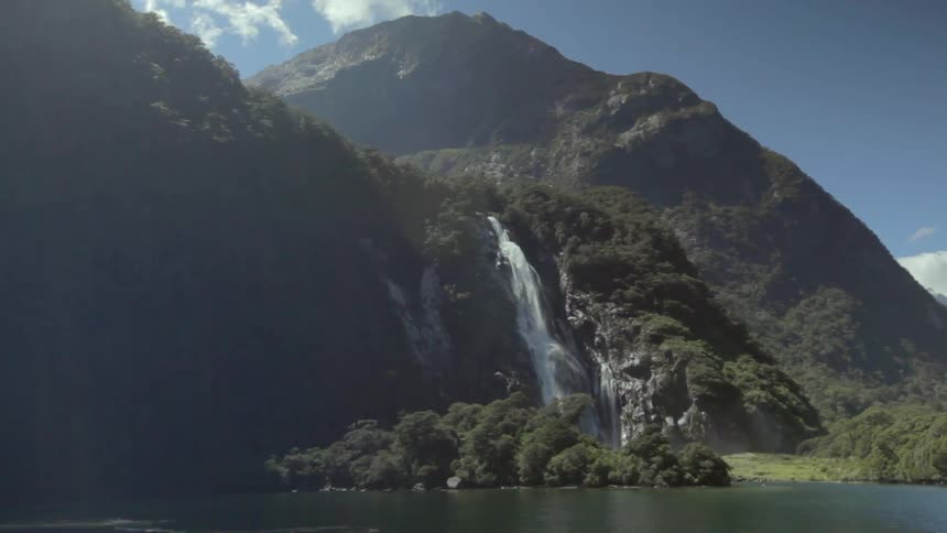 A waterfall gushes over a mountainside