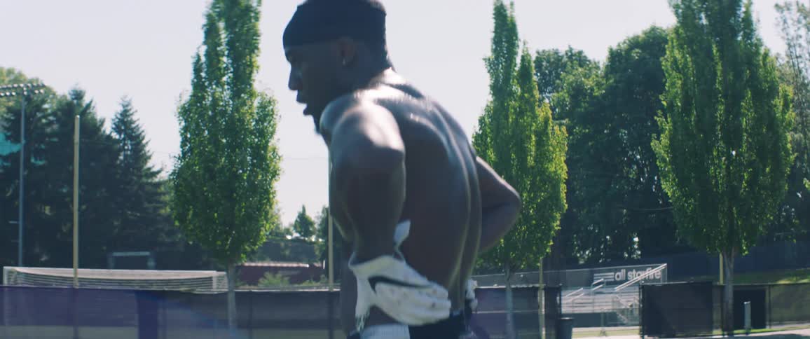 A man standing on a field and sweating