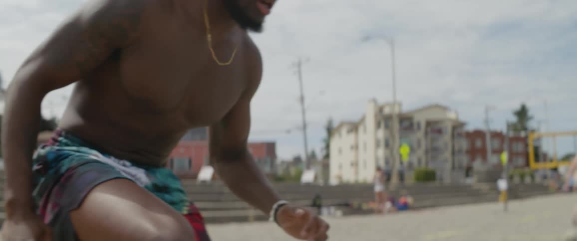 A man performs agility drills in the sand