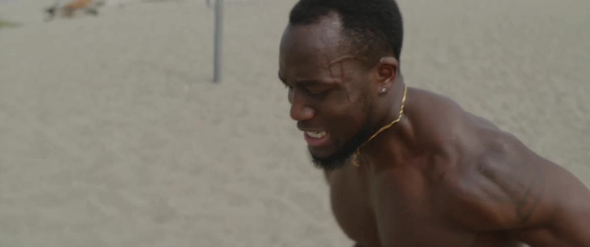 Men exercise on the beach