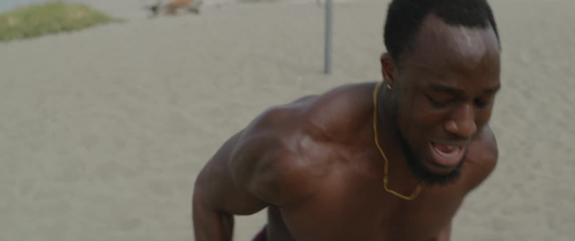 Man sprinting on a sandy beach