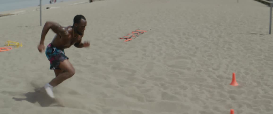 A man runs back and forth then catches a football