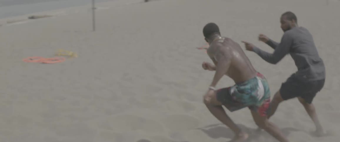 Men exercise on the beach