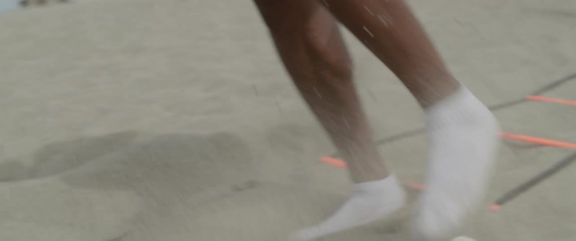 A man is exercising on the beach