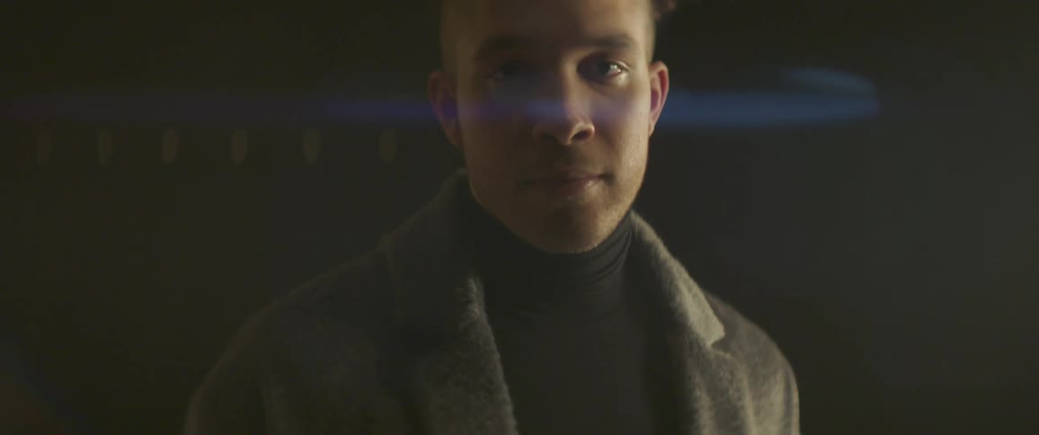 A man wearing a long wool jacket is shown