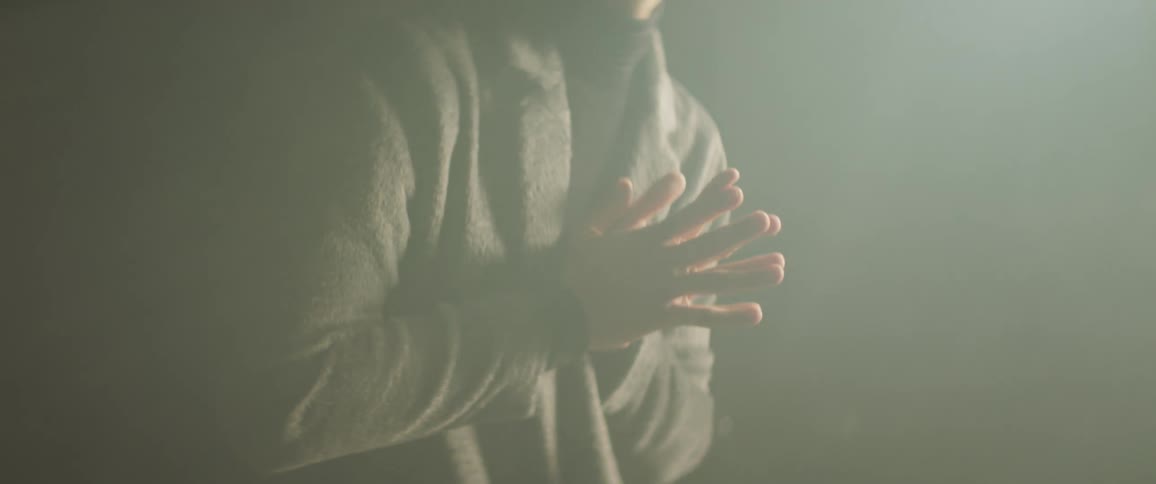 A man is wringing his hands