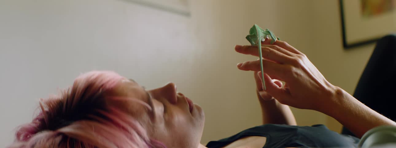 A woman holds her pet lizard