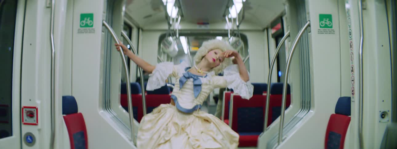 A woman in a costume is dancing on the train