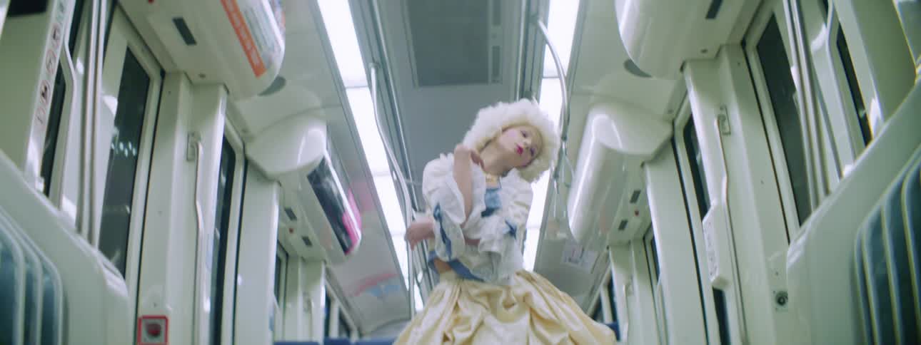 A teenage girl dances on a bus